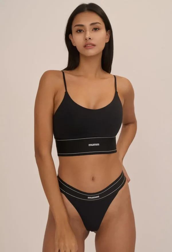 Black Elasctic 4mm Thong worn by a model while posing confidently in a close-up shot