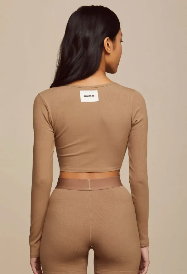 Back view of shiitake cropped cardigan with matching bike shorts displaying brand label and fitted design