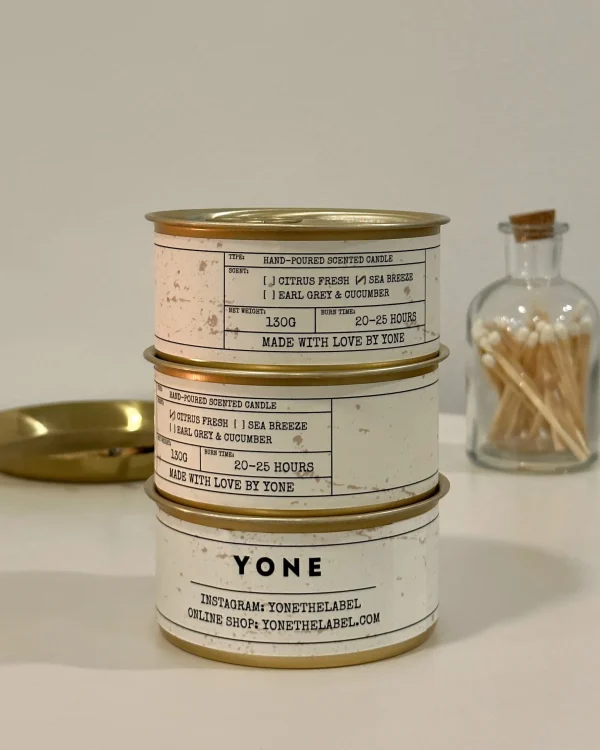 YONE brand Daily Reminder Candle collection featuring citrus fresh and sea breeze scents in gold metallic containers