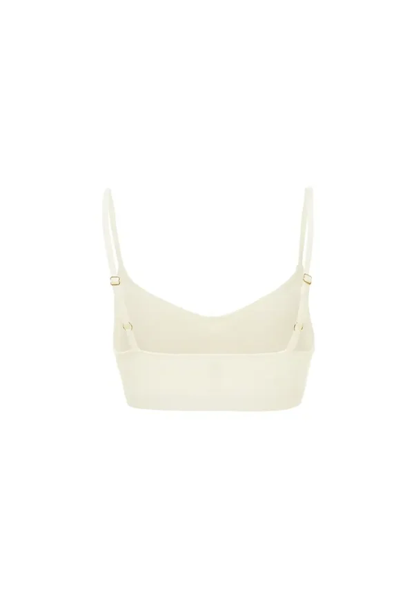 Product image showing chill vibe bra top in white with simple V-neck construction and strap adjustability